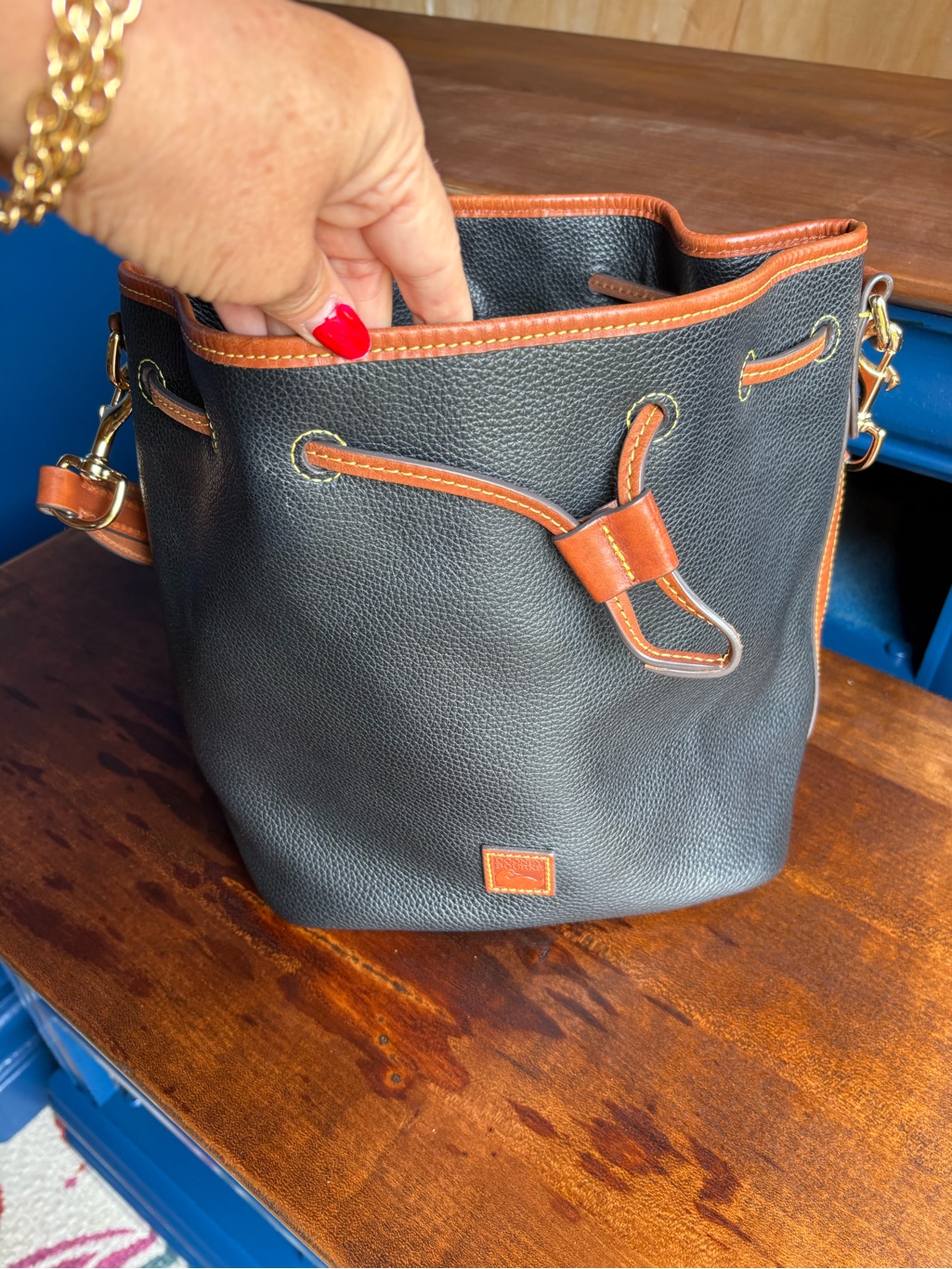 Dooney & Bourke Black With Brown Trim Pebbled Leather Bucket Shoulder Bag